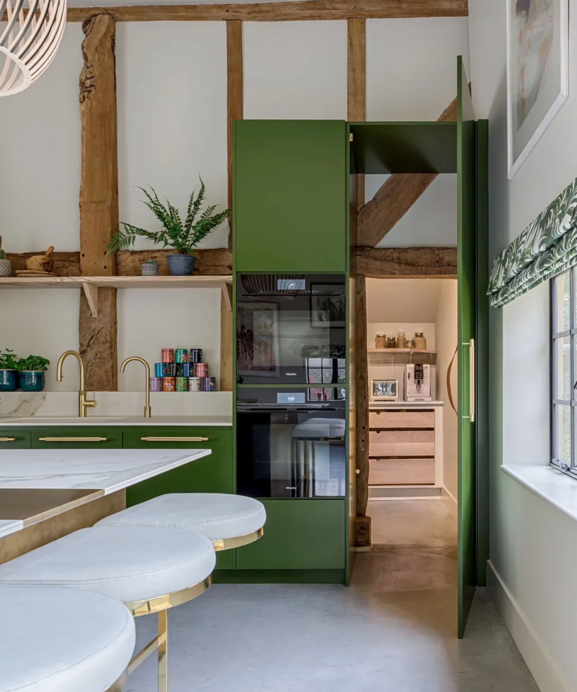Kitchen with hidden green door opening up into a room behind it