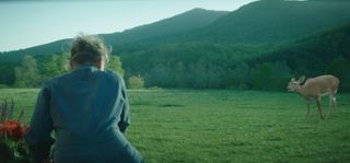 Frances McDormand looking at a fawn