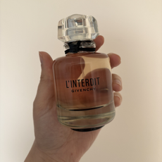 Mica Ricketts holding Givency L'Interdit EDP