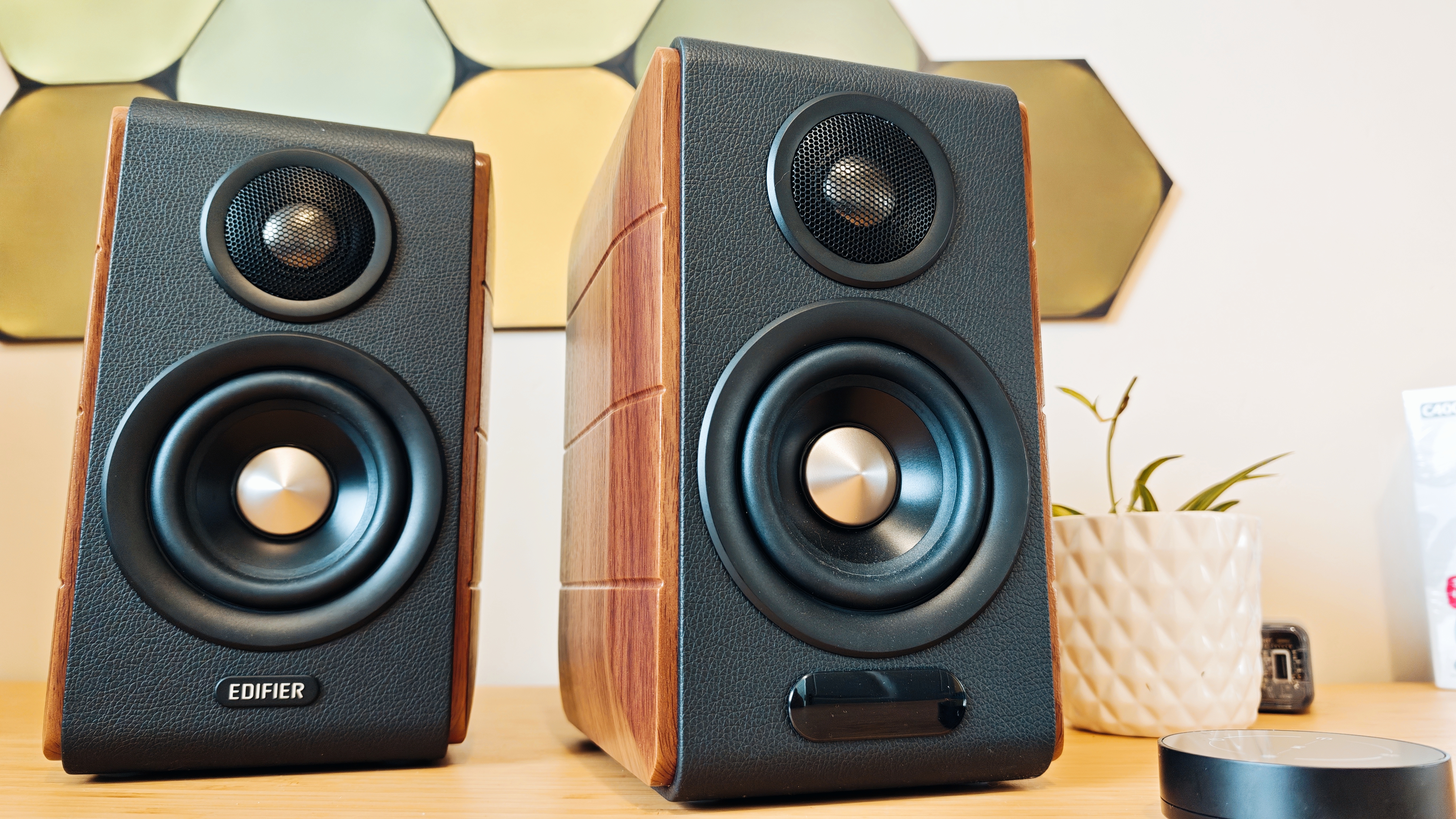 Black and brown Edifier S880DB MkII speakers on a wooden desk