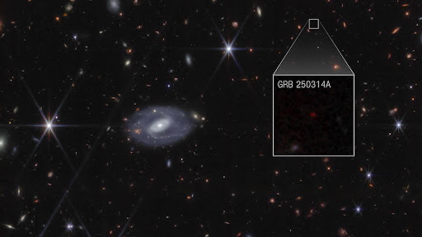 An image of space showing stars and galaxies with a box out in the top right quadrant showing the location of the supernova in the image. An inset zoomed-in image shows a red dot that represents the supernova.
