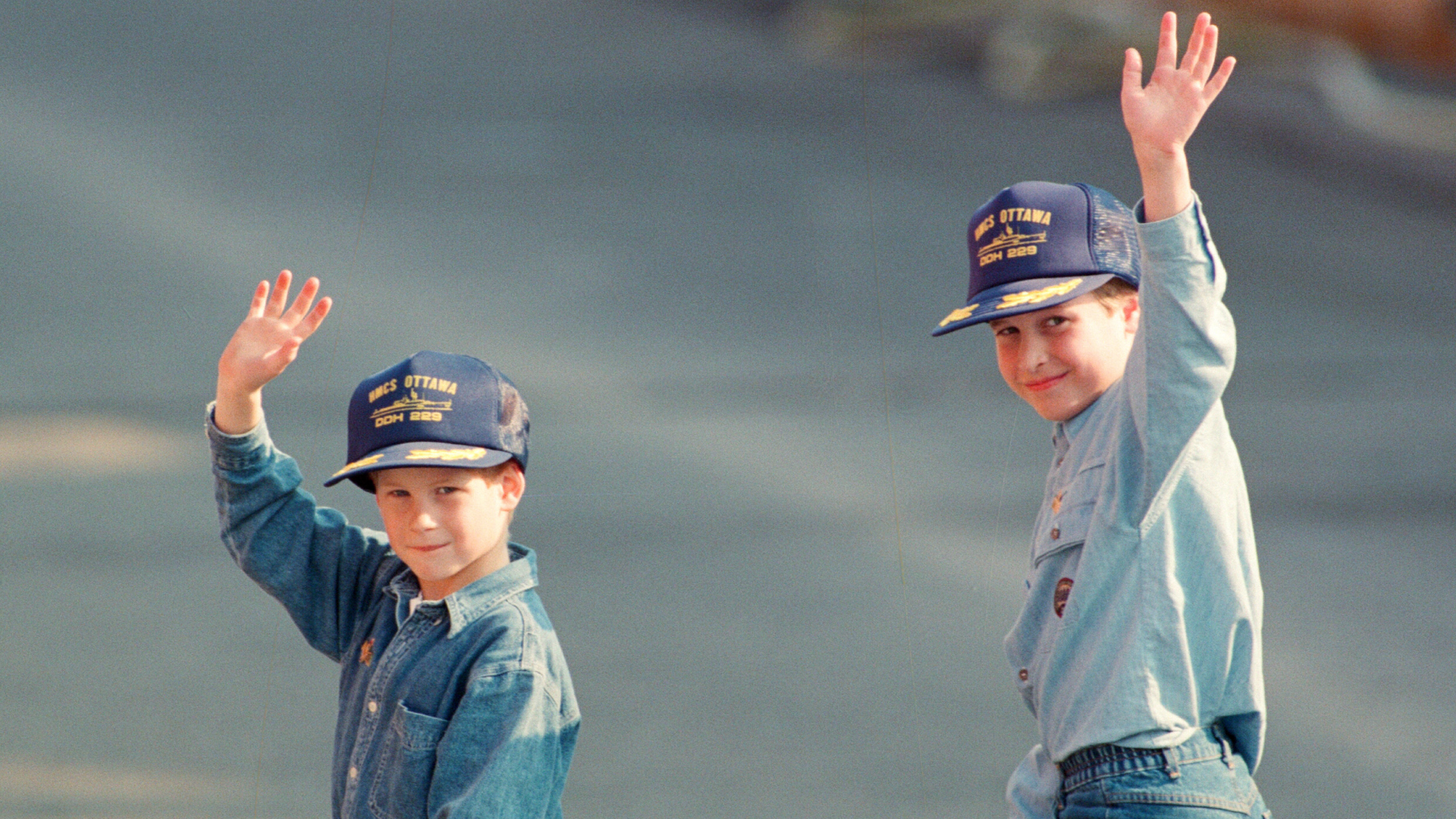Prince William and Prince Harry waving in jeans and denim shirts