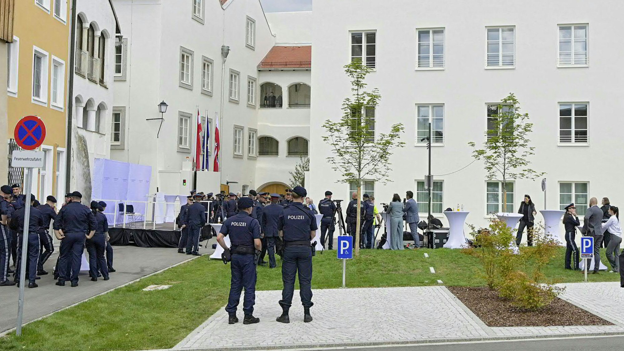 Police officers, journalists and guests outside the birthplace of Adolf Hitler