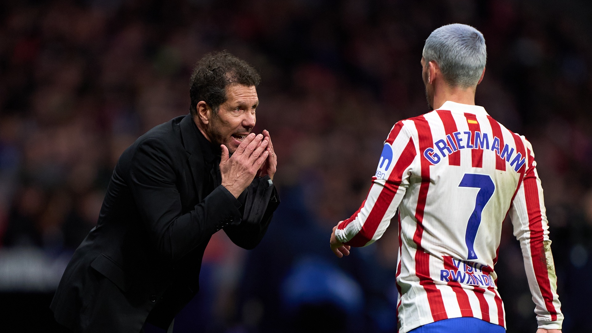 Diego Pablo Simeon gives instructions to his Atletico Madrid player Antoine Griezmann.