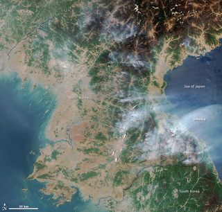 An image taken by the Moderate Resolution Imaging Spectroradiometer (MODIS) on NASA's Aqua satellite in April 2014 shows pinpricks of fire across North Korea.
