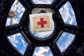 To honor the frontline medical workers of the COVID-19 pandemic on the 75th anniversary of Victory in Europe Day, which marked the end of World War II in Europe, NASA astronaut Andrew Morgan tweeted this photo of a WWII medical armband floating in the Cupola observatory of the International Space Station. "Much like first responders on the frontlines today, 75 years ago combat medics bravely faced grave danger to save fellow #Soldiers on the battlefield," Morgan tweeted May 8. "This WW2 medical armband accompanied me to @space_station and will soon reside @NatlArmyMuseum." Morgan returned from the space station in April after spending 272 days on board the orbiting lab.