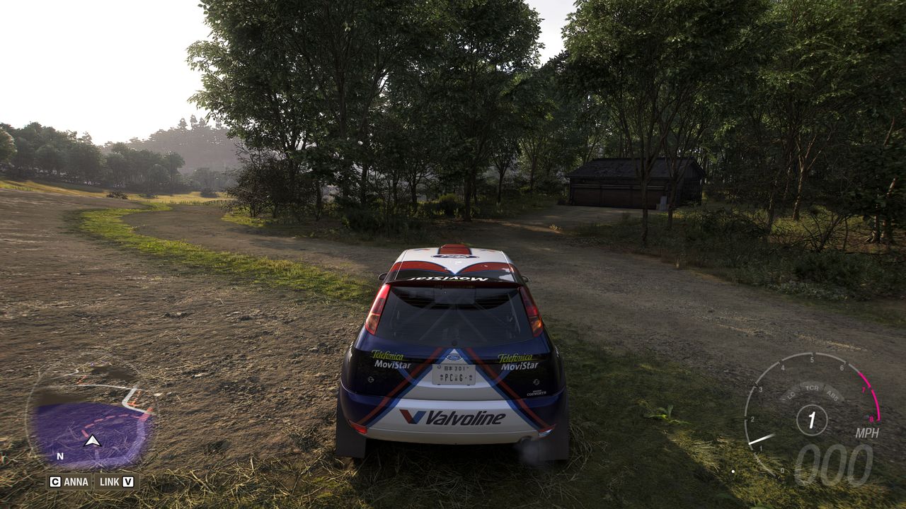 Forza Horizon 6 Barn Finds: A player parked outside an old wooden barn in a forest ahead.