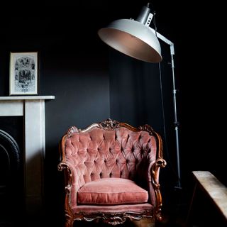 black walls with armchair and lamp