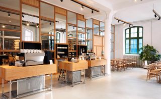The coffee stands are integrated within the main seating area, while the roasting room can be seen behind