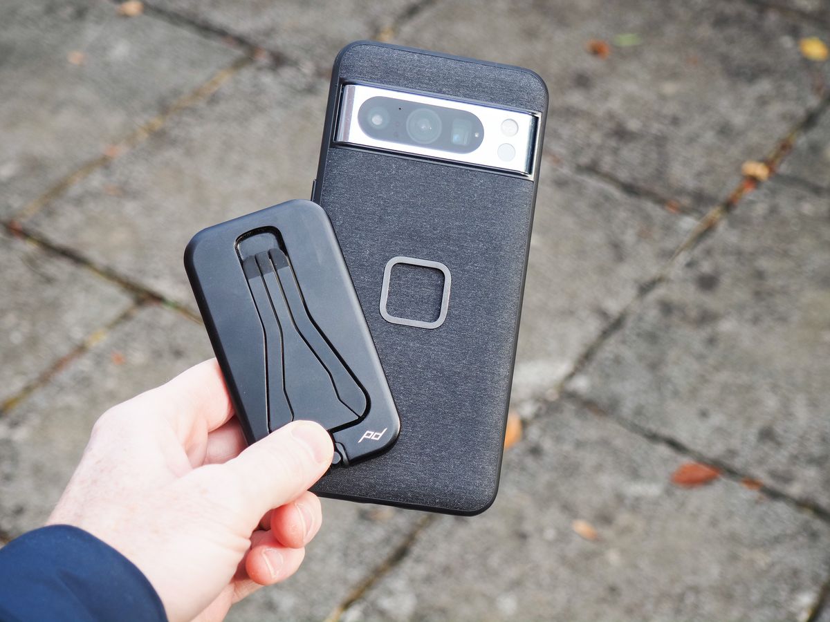 Peak Design Mobile Tripod folded away, in user's hand alongside a Pixel phone with Peak Design's dedicated case