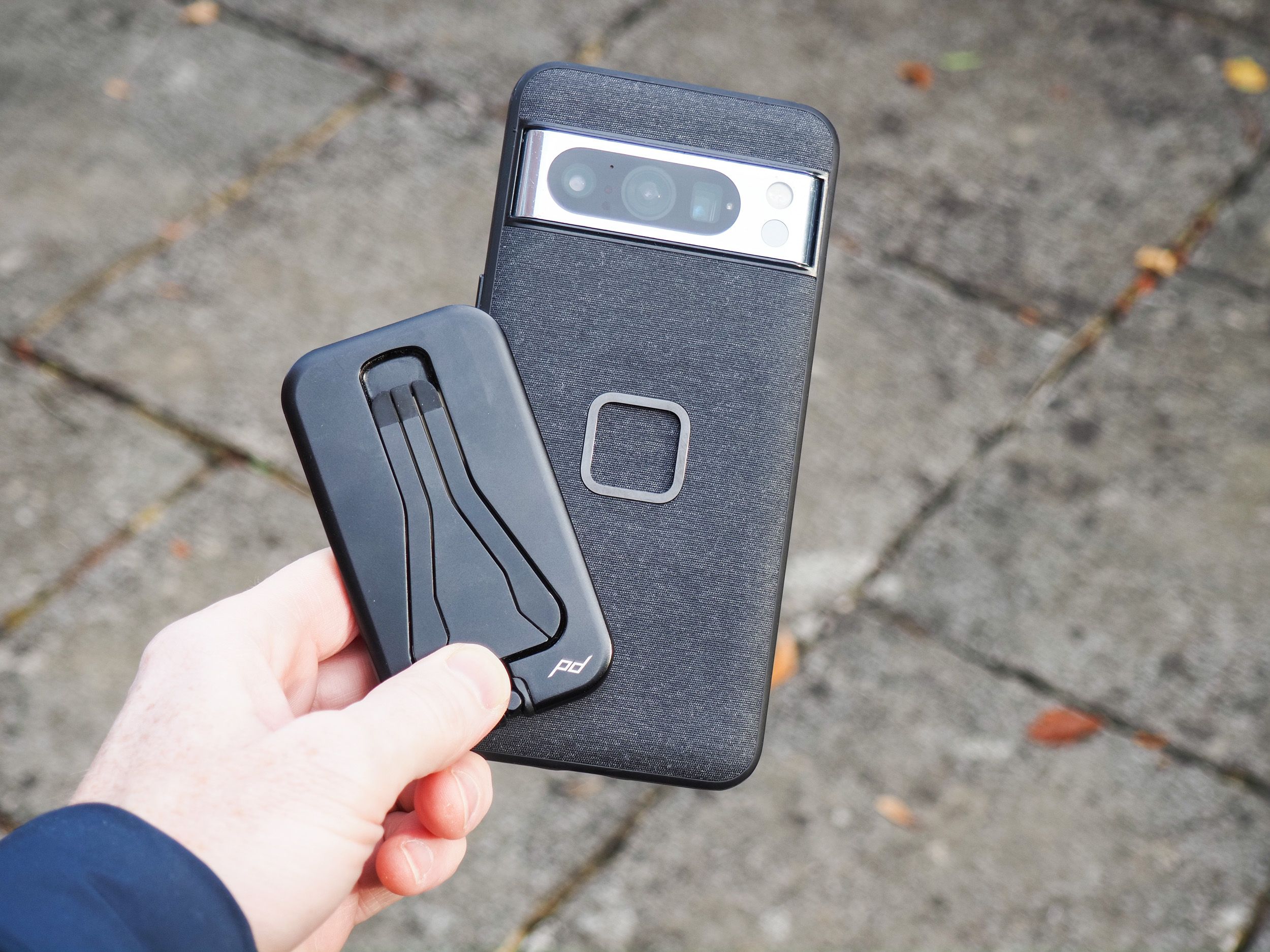 Peak Design Mobile Tripod folded away, in users hand alongside a Pixel phone with Peak Designs dedicated case