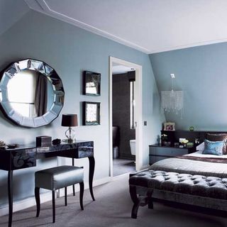 bedroom with grey wall and mirror on wall
