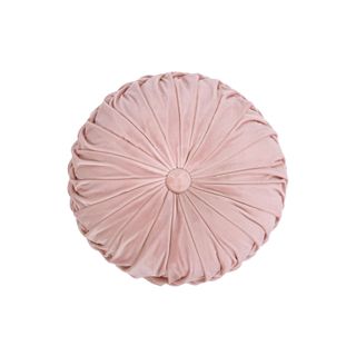 A pink circular accent cushion
