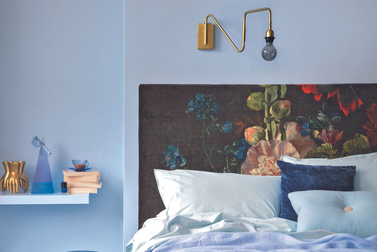 lavender walls and floral headboard in a bedroom