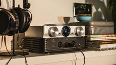 Lifestyle photos of the iFi iDSD Phantom with a pair of open-back headphones next to it