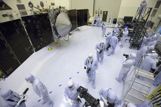 Inside the Payload Hazardous Servicing Facility at NASA's Kennedy Space Center in Florida, reporters and photographers look over the Mars Atmosphere and Volatile Evolution, or MAVEN, spacecraft on Sept. 27, 2013. The Mars orbiter is due to launch on Nov. 17, 2013.