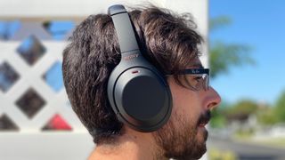 a man wearing the Sony WH-1000XM4 wireless headphones