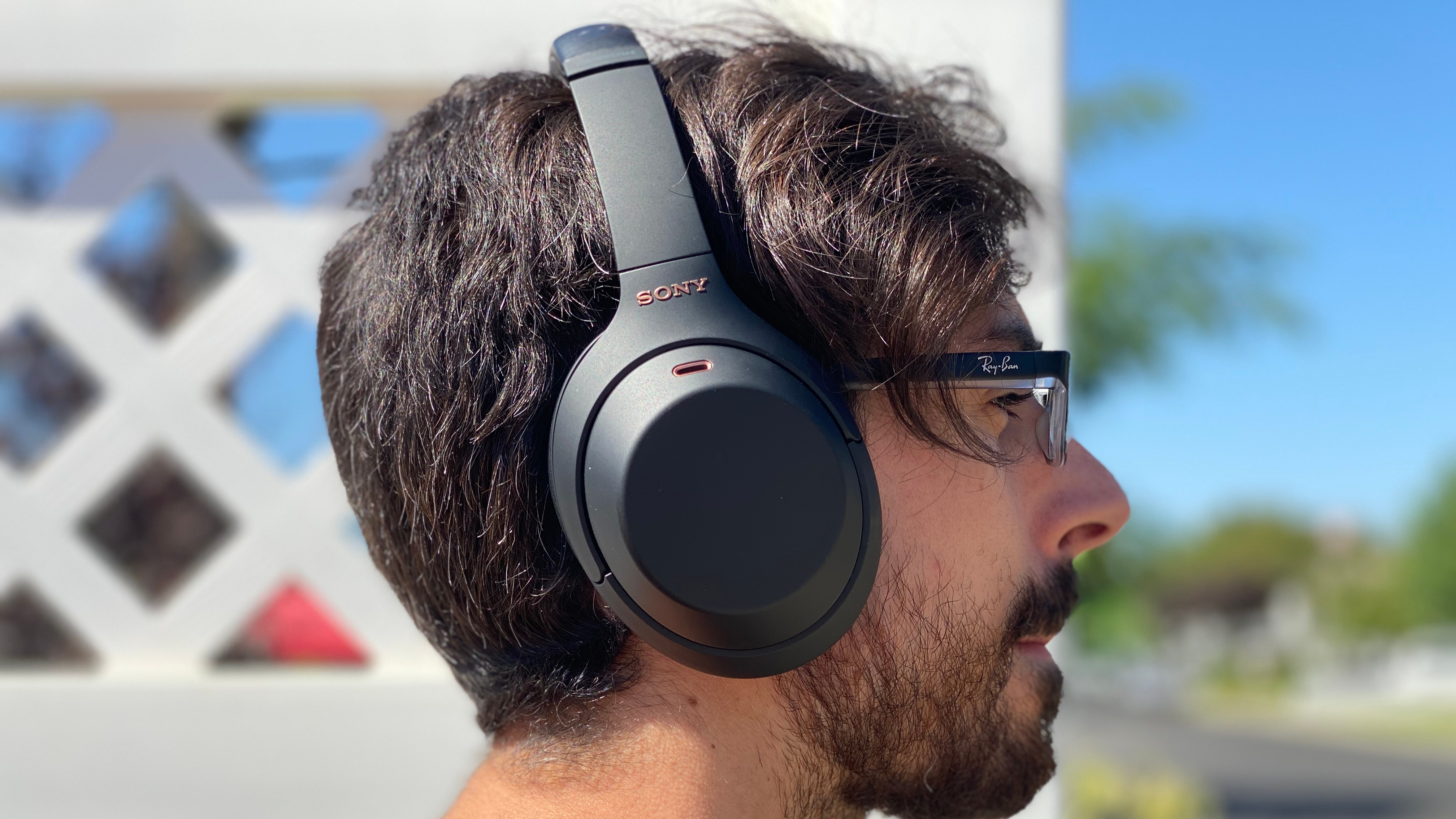 A man wearing a pair of the sony wh-1000xm4 headphones