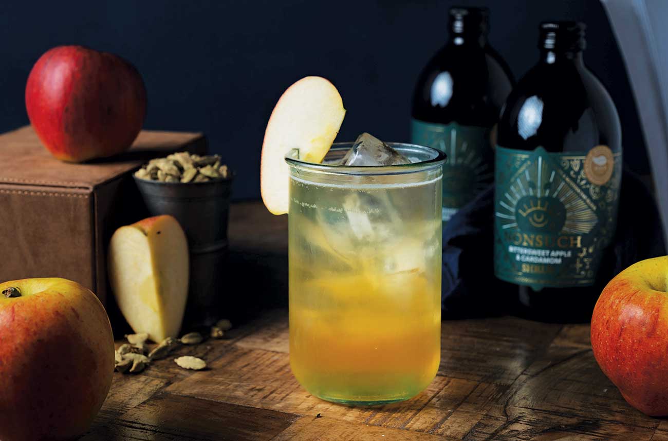 Bottles and glass of Nonsuch Bittersweet Apple &amp; Cardamom Shrub