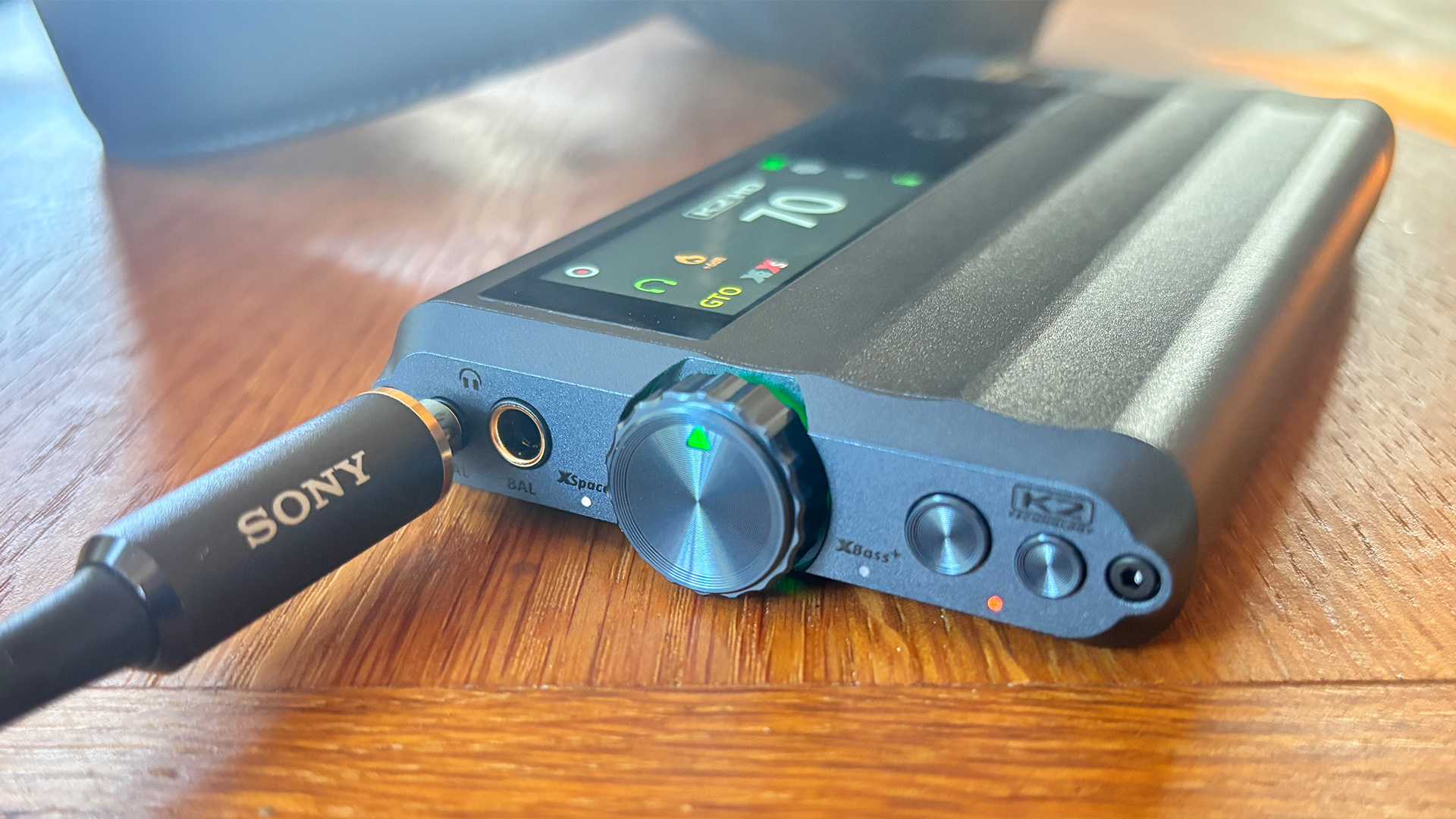 iFi iDSD GR 2 DAC on wooden desk with Sony branded jack lead plugged into front