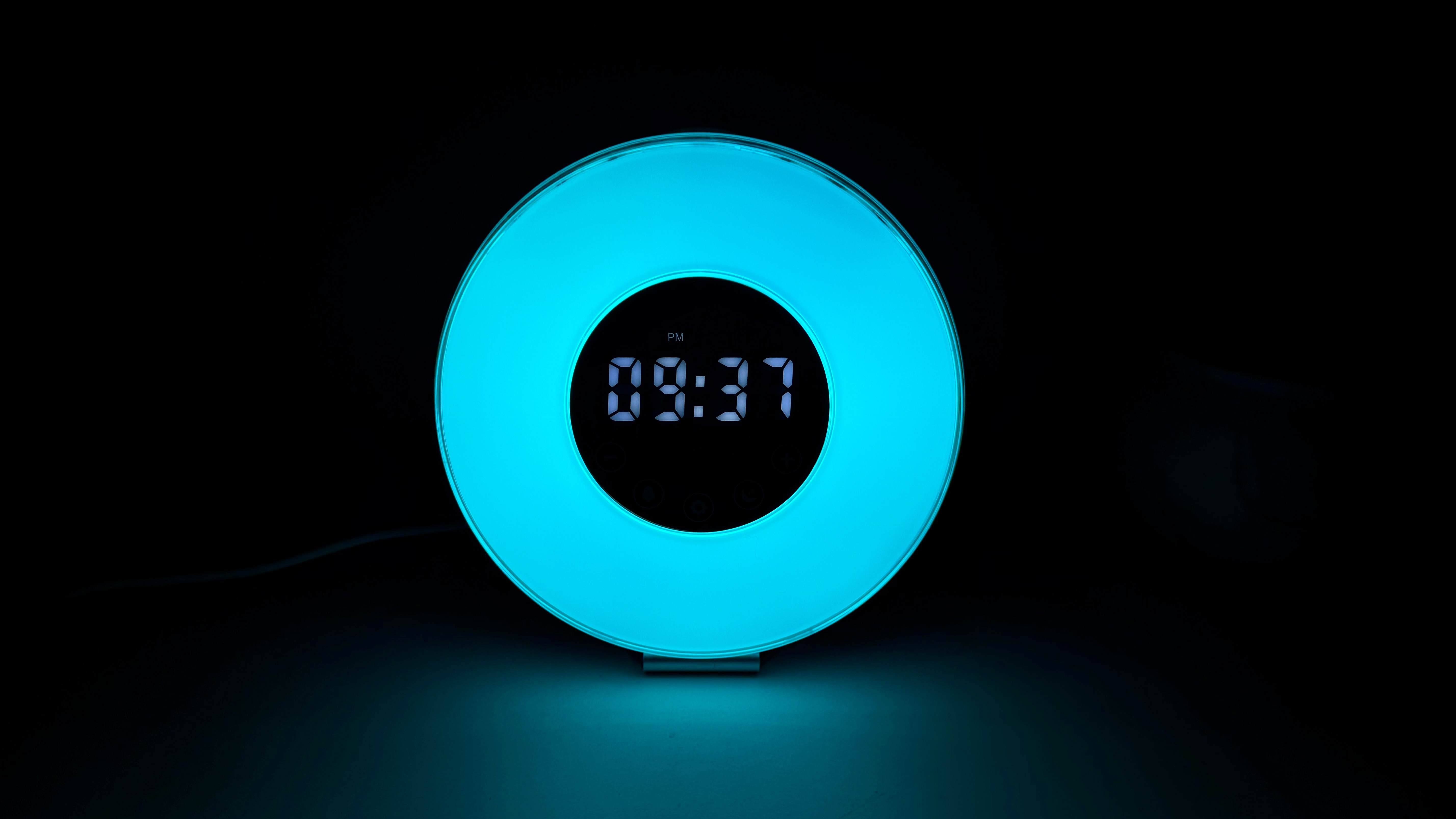 HomeLabs sunrise alarm clock with digital time on screen surrounded by turquoise ring light.