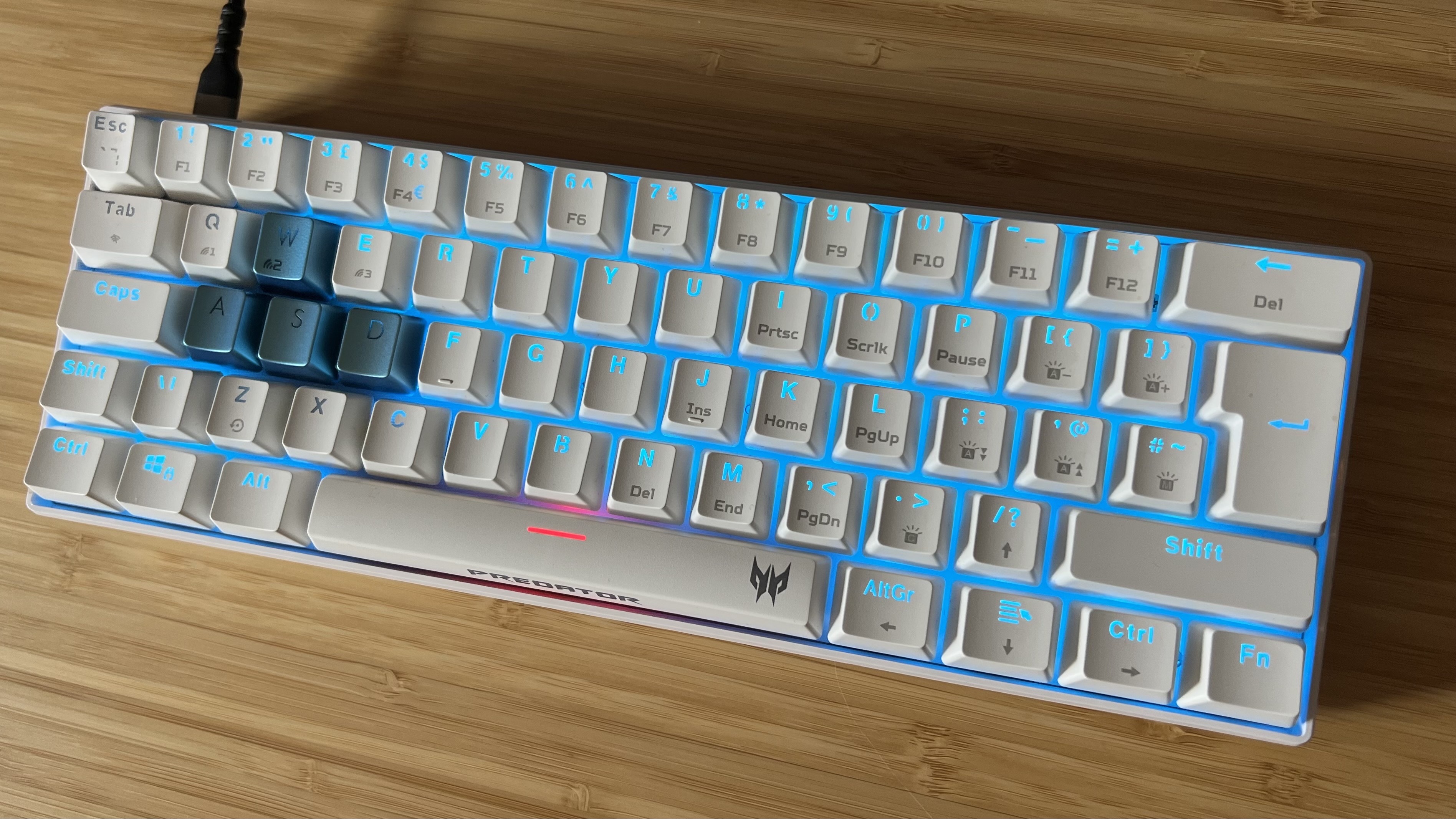 Acer Predator Aethon 330 gaming keyboard with RGB enabled on a wooden desk