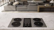 Plessers integrated hob in a marble countertop island
