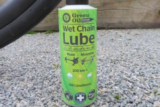 Bottle of Green oil wet chain lube which is one of the best chain lubes for bikes