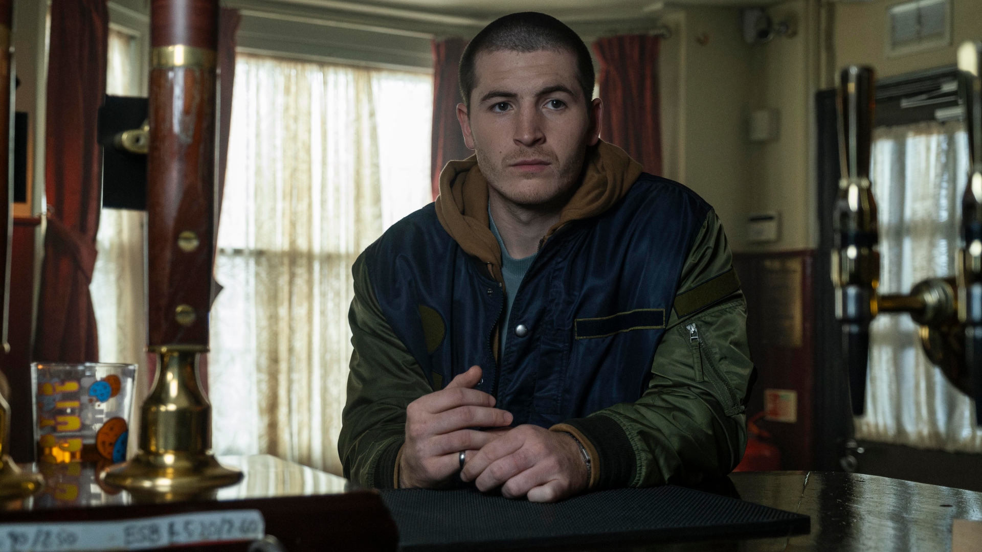 Liam sits at the bar