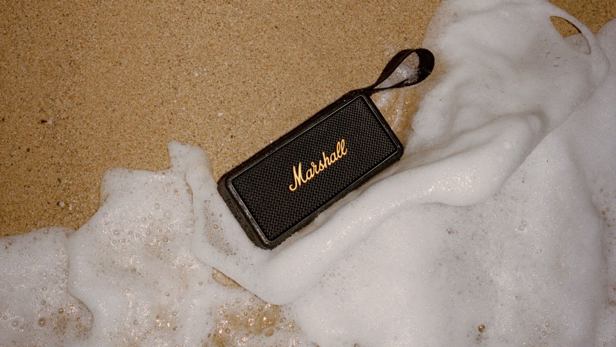 Marshall Middleton speaker on sandy beach with water rushing in 