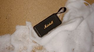 Marshall Middleton speaker on sandy beach with water rushing in 
