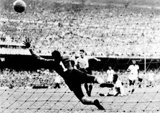 Juan Alberto Schiaffino scores for Uruguay against Brazil at a packed Maracana in the 1950 World Cup.