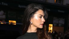 Anne Hathaway wearing band tee and suit trousers at Paris Fashion Week, 4 October 2025