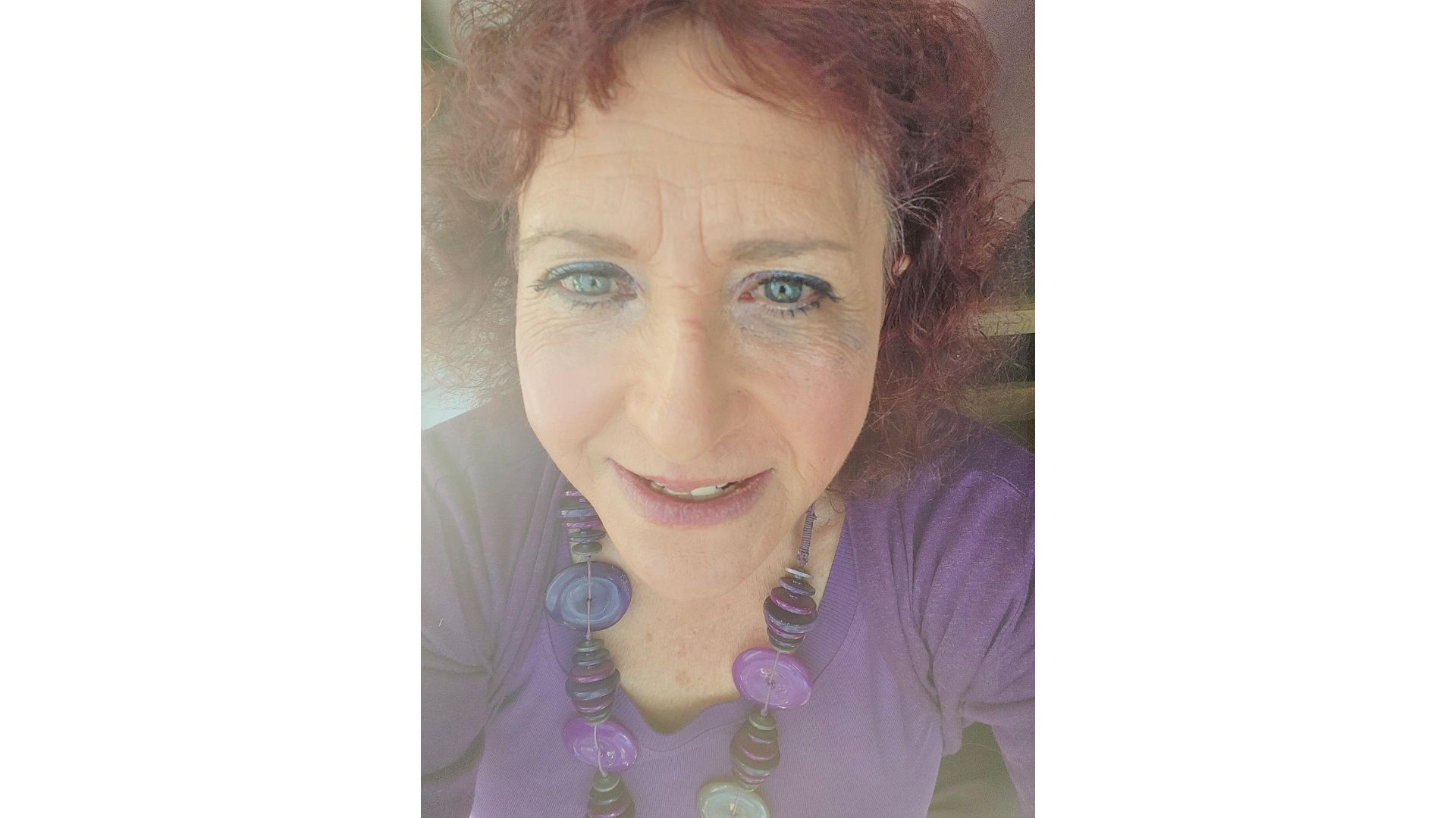 A headshot of retiree Maria Fuccio wearing the purple WASPI campaign colours