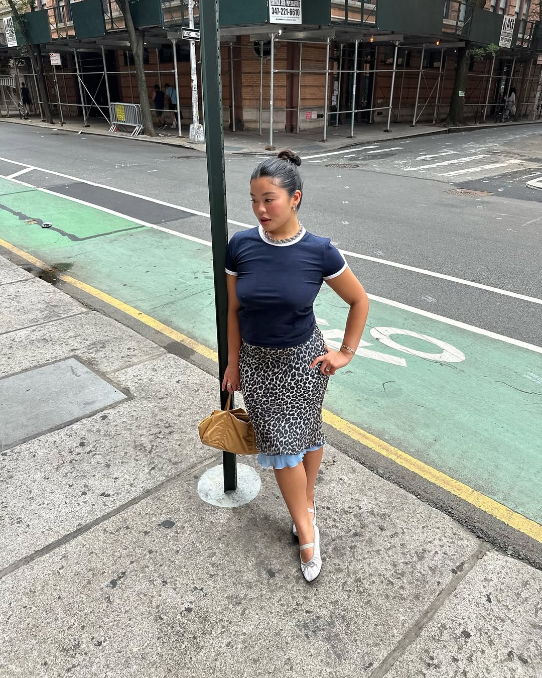 Woman wearing knee-length skirt outfit summer 2025.