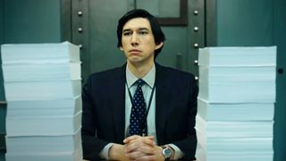 Adam Driver sitting at a desk surrounded by papers in The Report
