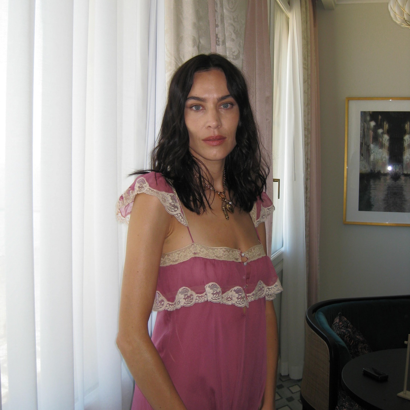 Alexa Chung wearing a pink lace dress with a lob hairstyle