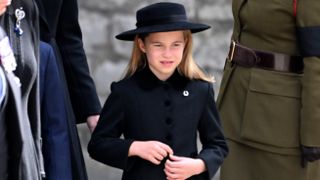 Princess Charlotte wearing a horse shoe brooch at Queen Elizabeth II's funeral