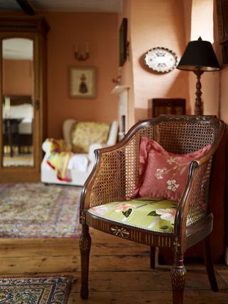 wooden chair with cushions on a rug