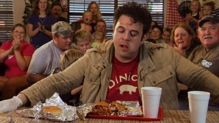 Adam Richman sweating while trying to finish the Shut-Up Juice pork sandwich