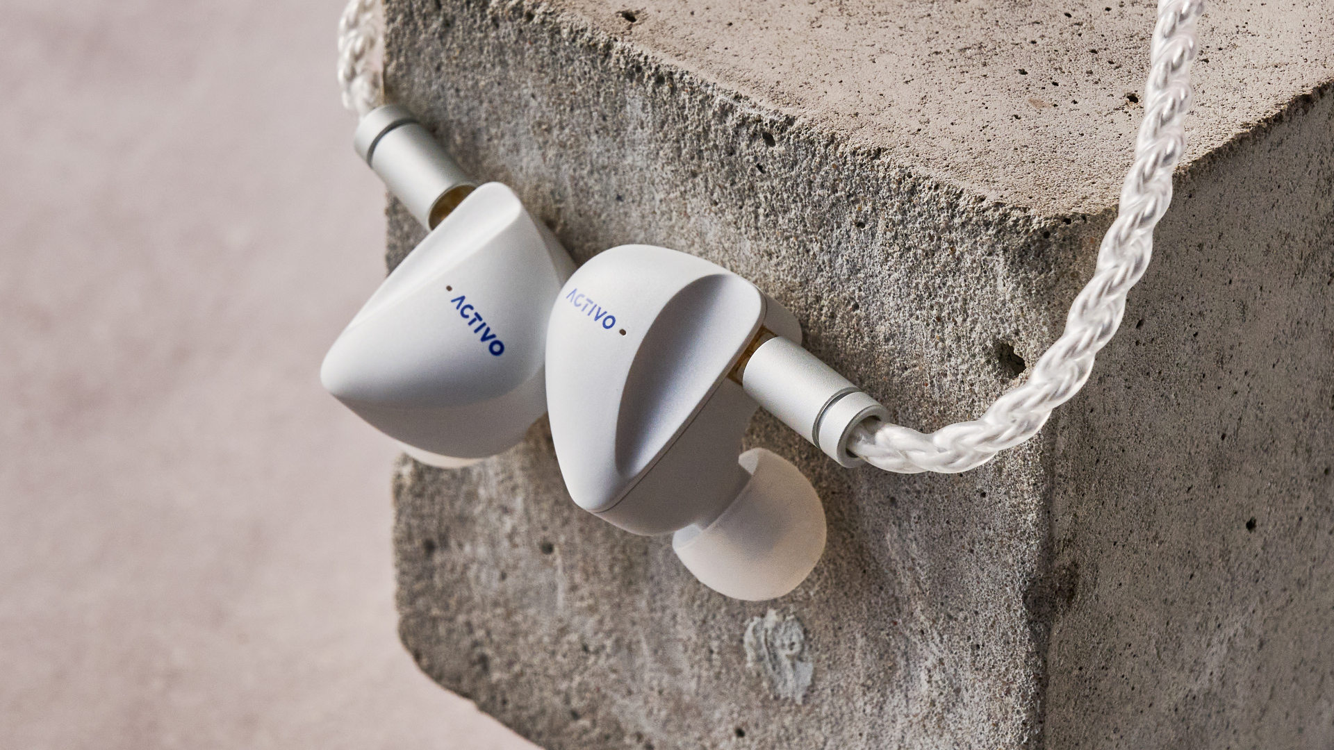 Activo Scoop earbuds hanging on block