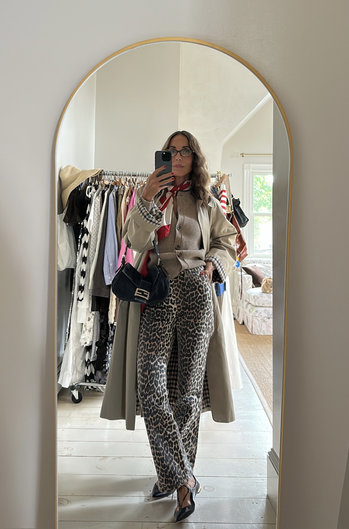 Larissa Mills wearing cheetah print jeans, a tan sweater, and tan coat