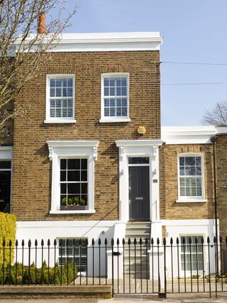 A victorian terrace house with iron railings at the front