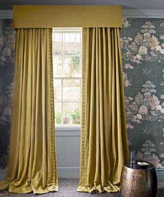 Yellow drapes with purple patterned wallpaper