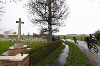 Peloton passing through the Flanders Fields World War Graveyard during 2023 Gent-Wevelgem in Flanders Fields 