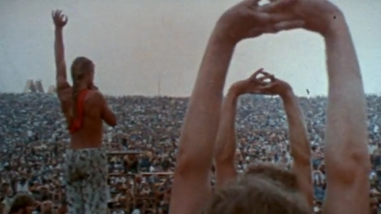 The crowd doing yoga in the original Woodstock movie