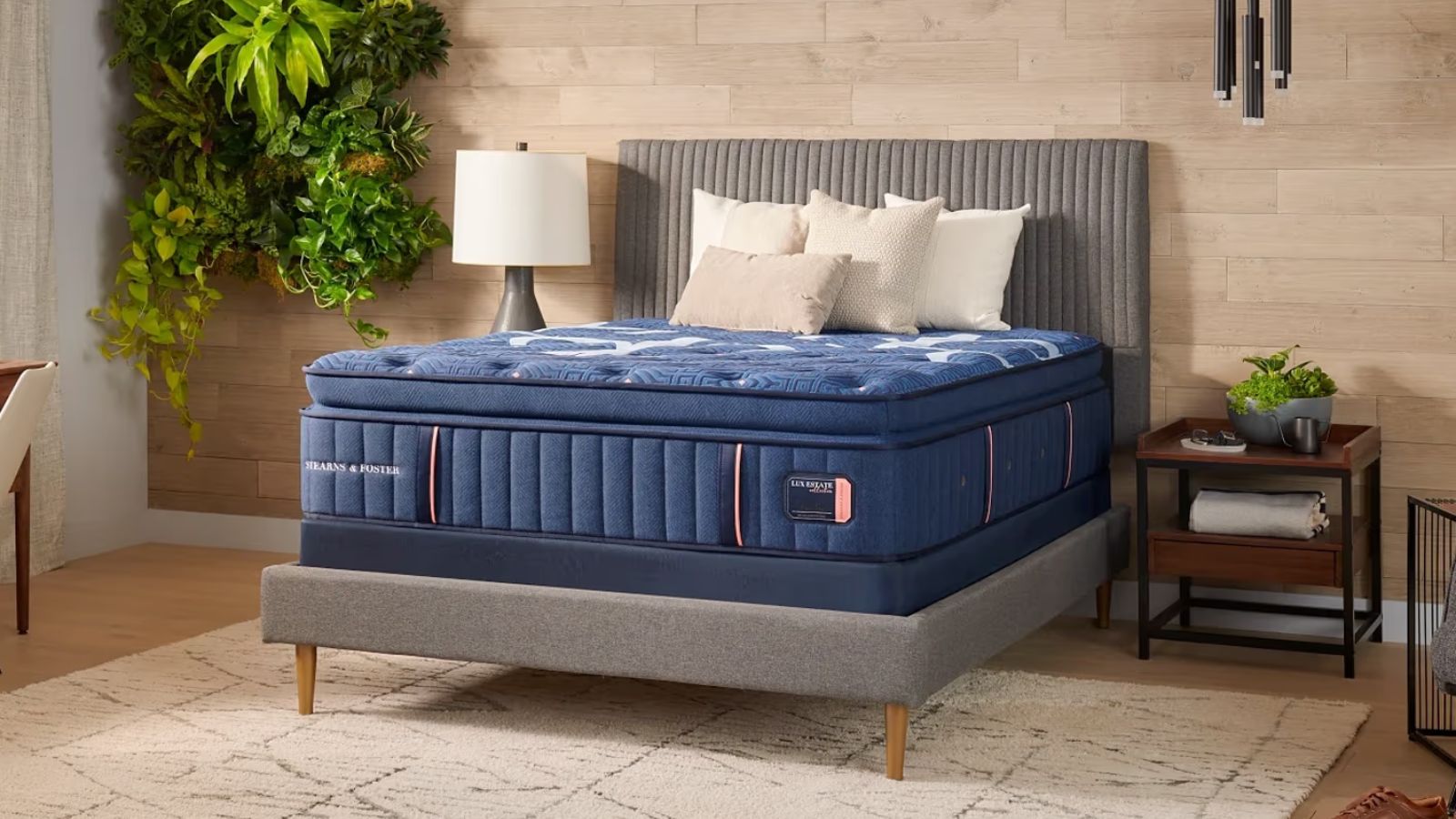 Stearns &amp; Foster Lux Estate Mattress on a bed against a wooden wall. 