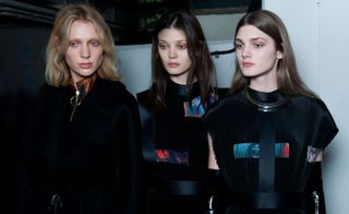 Three female models backstage at the Thomas Tait A/W 2015