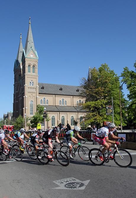 The men's field rides past the local church