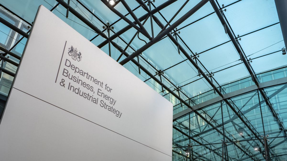 A governmental sign for the Department of Business, Energy &amp;amp; Industrial Strategy with glass ceiling in background